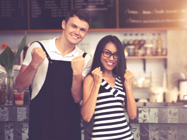 a man in an apron and a woman standing next to him