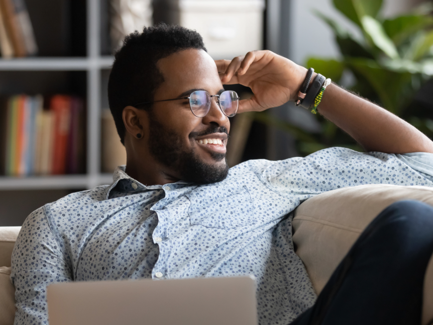 man in glasses looking out the window