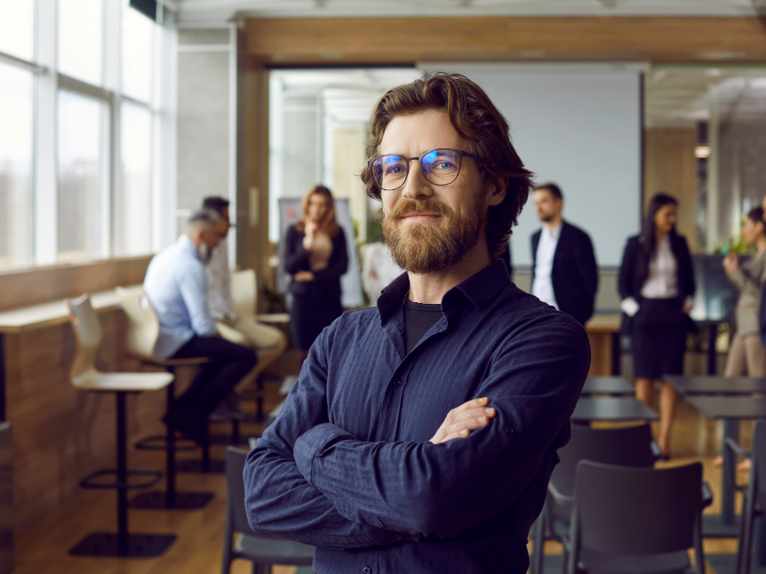 man in glasses folding his arms